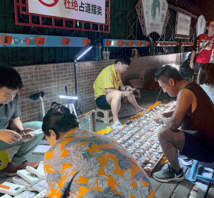 不少人甚至坐在摊贩前慢慢寻宝。 不少人甚至坐在摊贩前慢慢寻宝。